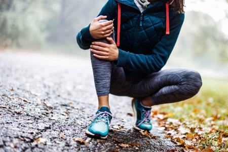 Woman grabbing knee in pain