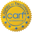 circular gold medal icon stating ASPIRE to Excellence, with the acronym carf in the center, with ACCREDITED below it