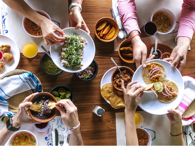 Family at table sharing food